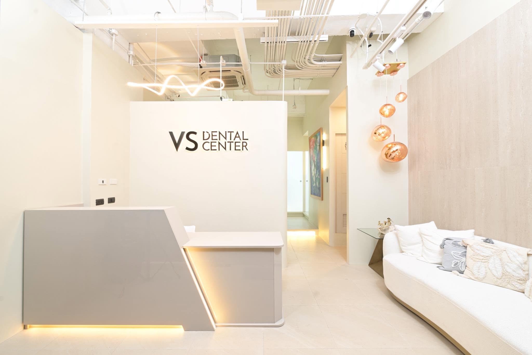 VS Dental Center Paseo reception — fluted counter, cream sofa, copper pendant lights